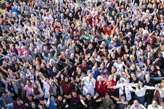A large group of IU School of Dentistry students and professors wave at the camera.
